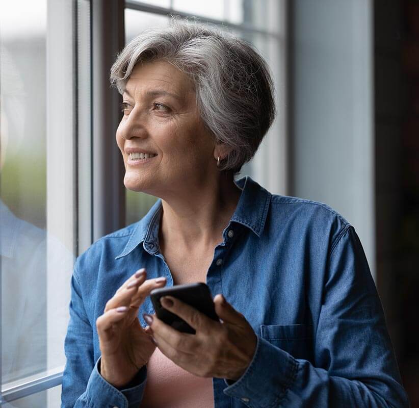 Woman smiling looking at her phone